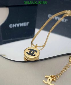 Gold pendant necklace with designer logo.