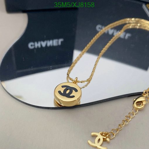 Gold pendant necklace with designer logo.