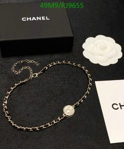 Chanel branded necklace and box with white flower decoration.