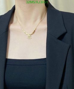 Person wearing necklace and blue blazer.