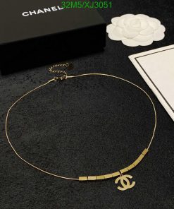 Elegant designer gold necklace on black background.