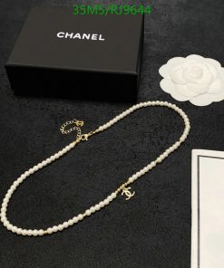 Pearl necklace with logo beside luxury brand box.