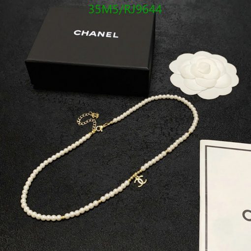 Pearl necklace with logo beside luxury brand box.