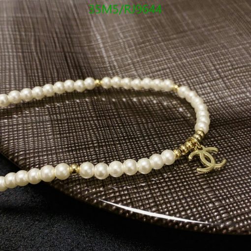 Elegant pearl necklace with gold accent on textured surface