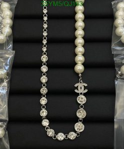 Elegant pearl and rhinestone necklaces on black background.