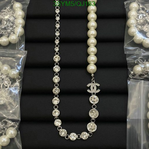 Elegant pearl and rhinestone necklaces on black background.