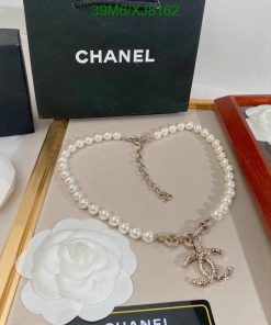 Chanel pearl necklace with logo pendant on display.