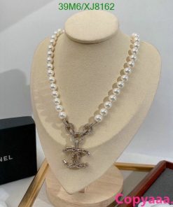 Elegant pearl necklace with pendant on display.