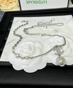 Pearl necklace with white rose backdrop on display