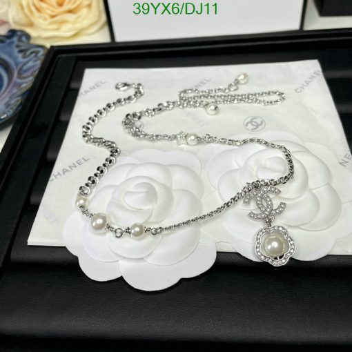 Pearl necklace with white rose backdrop on display