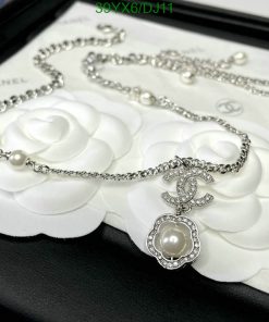 Elegant pearl and diamond necklace on floral display.