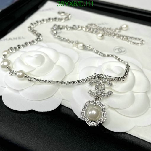 Elegant pearl and diamond necklace on floral display.