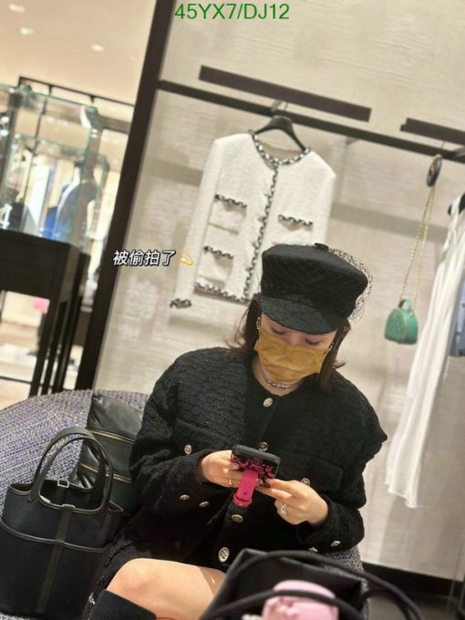 Woman in boutique using smartphone.