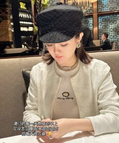 Woman in hat dining at upscale restaurant.