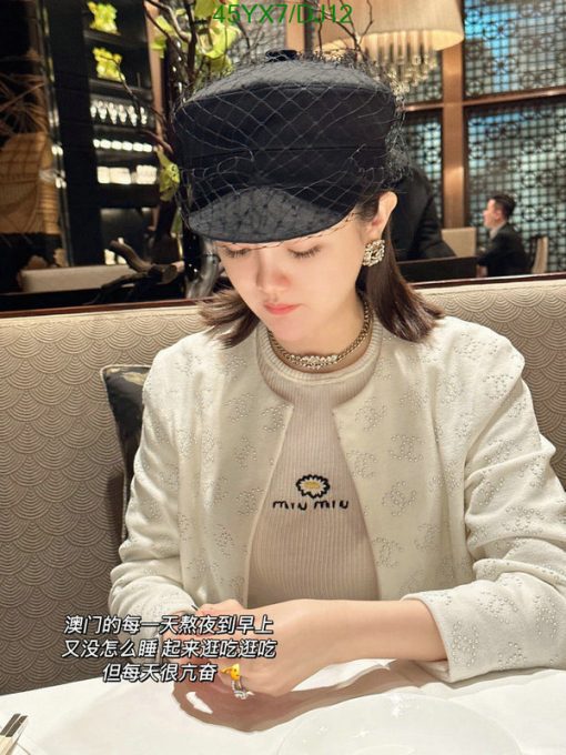 Woman in hat dining at upscale restaurant.