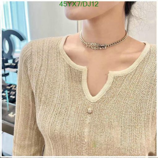 Woman wearing gold knit sweater and choker necklace.