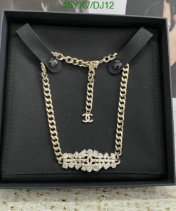 Gold chain necklace with pendant in display box.