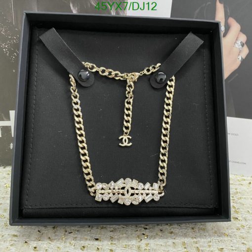 Gold chain necklace with pendant in display box.