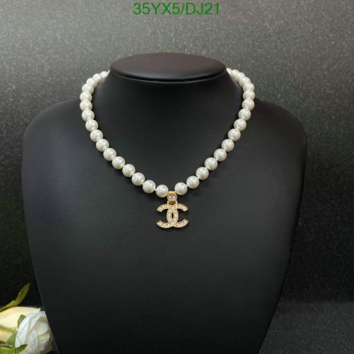 Elegant pearl necklace with anchor pendant on black display.