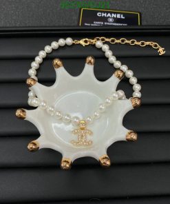 Chanel pearl necklace with ceramic ashtray and logo.