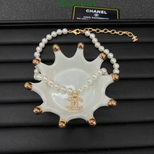 Chanel pearl necklace with ceramic ashtray and logo.