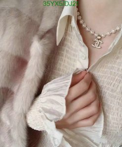 Elegant pearl necklace and chic fur coat fashion.