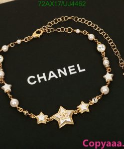 Gold star and pearl Chanel bracelet on display.