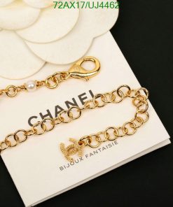 Gold bracelet with pearls on white background.