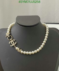 Pearl necklace with diamond pendant on display mannequin.