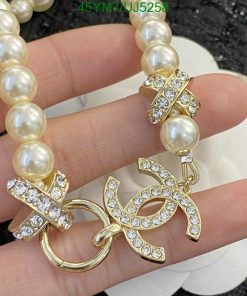 Pearl necklace with gold and rhinestone clasp.