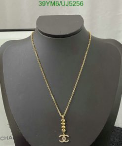 Gold anchor pendant necklace on bust display.