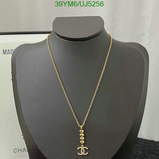 Gold anchor pendant necklace on bust display.