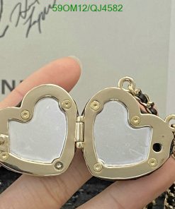 Gold heart-shaped locket open in hand.