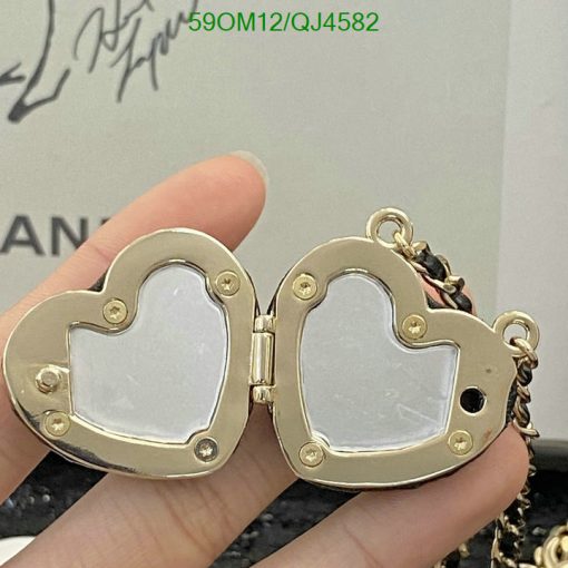 Gold heart-shaped locket open in hand.