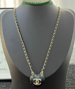 Designer heart pendant necklace on mannequin display.