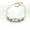 Pearl necklace with celestial star and moon accents.