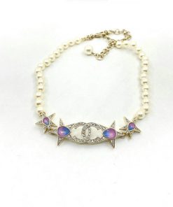 Pearl necklace with celestial star and moon accents.