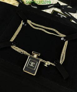 Designer pendant on gold chain, luxury fashion accessory.