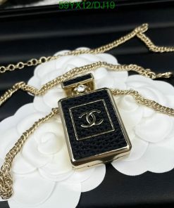 Designer perfume bottle pendant on gold chain.