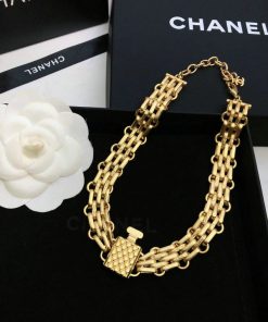 Gold Chanel perfume bottle-shaped necklace with packaging.