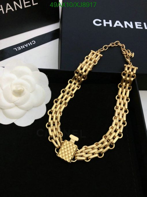 Gold Chanel perfume bottle-shaped necklace with packaging.