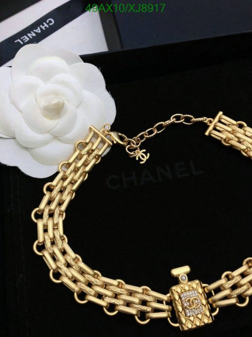 Designer gold-tone chain belt with white flower.