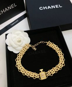 Gold chain bracelet on designer brand box.