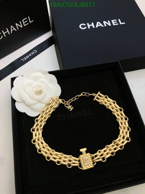 Gold chain bracelet on designer brand box.