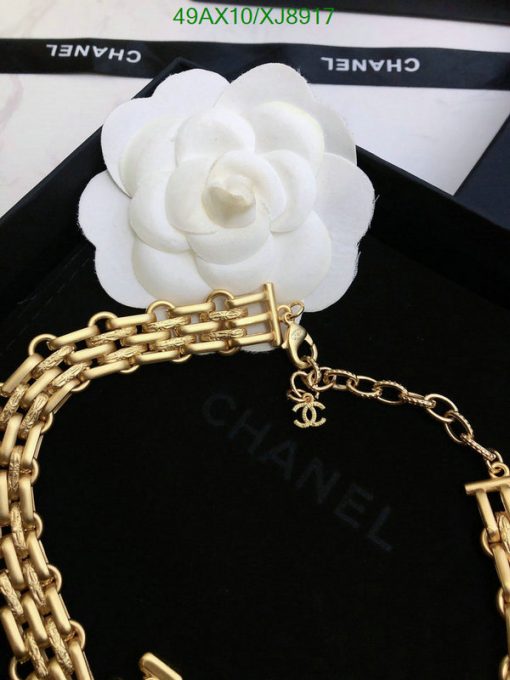 Designer gold chain necklace with white camellia flower.