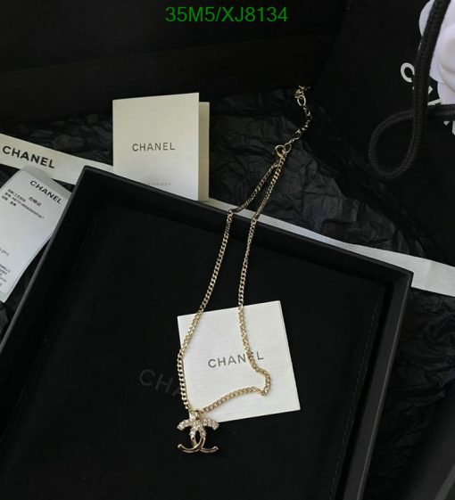 Chanel necklace with pendant in black presentation box.