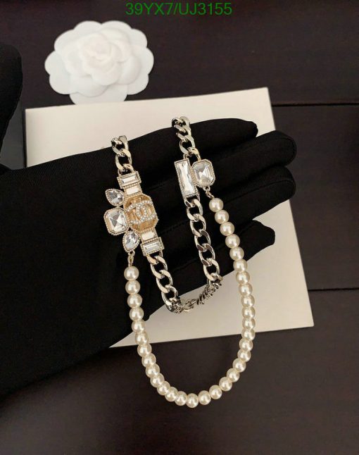 Elegant pearl necklace with diamond-studded clasps on display.