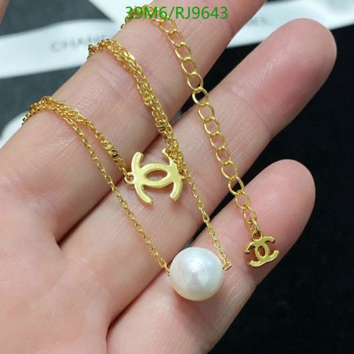 Gold bracelets with charm and pearl detail.