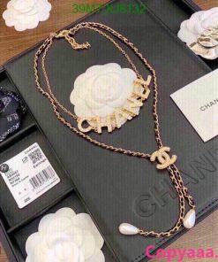 Chanel gold-tone logo necklace with packaging.