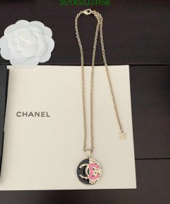 Chanel necklace with logo pendant on white background.